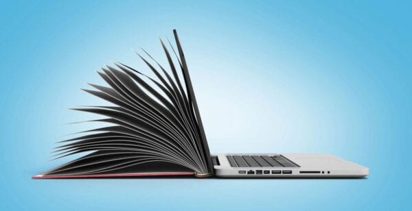A laptop and an open notebook