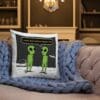 A pillow with an alien cartoon on it