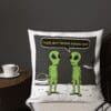 A pillow with two green aliens talking to each other.