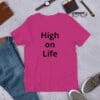 A pink t-shirt that says high on life.