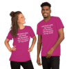 A man and woman wearing pink shirts with white lettering.