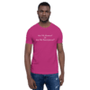 A man wearing a pink shirt and jeans.