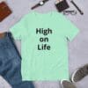 A person wearing jeans and a t-shirt with the words " high on life ".