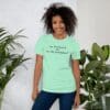 A woman standing in front of some plants wearing a t-shirt
