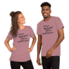 A man and woman wearing pink shirts with black lettering.