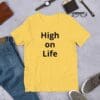 A yellow t-shirt that says high on life.