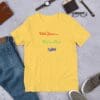 A yellow t-shirt sitting next to some jeans and a wallet.