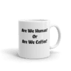 A coffee mug with the words are we human or are we coffee written on it.