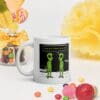 A white coffee mug with an alien cartoon on it.