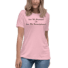 A woman wearing jeans and pink t-shirt with text.