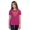 A girl wearing a pink t-shirt with the words " superget a chip off the old street ".