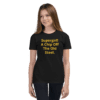 A girl wearing black jeans and a t-shirt.