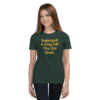 A girl wearing a green shirt with the words " supergrit, a chip off the old street ".