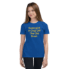 A girl wearing a blue shirt with the words " supergirl a chip off the old street ".