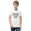 A boy wearing jeans and a t-shirt with the words " superboy ! a chip off the old steel ".