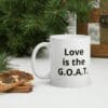 white-glossy-mug-11oz-christmas-61871b69a4263 A white coffee mug with the words love is the g. O. A. T on it