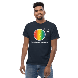 A man wearing a black t-shirt with a rainbow colored circle.