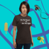 unisex-staple-t-shirt-brown-front-628f1d0897e2 A woman standing in front of a blue wall.