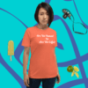 unisex-staple-t-shirt-heather-orange-fron-0017 A woman standing in front of a blue wall.