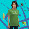 unisex-staple-t-shirt-leaf-front-628f1d089013b A woman standing in front of a green wall.