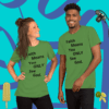 A man and woman wearing green shirts with the words " faith means you only see god ".