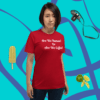 unisex-staple-t-shirt-red-front-628f1d089124c A woman standing in front of a blue wall.