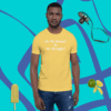 unisex-staple-t-shirt-yellow-front-628f1c0087c A man wearing a yellow shirt with some fruit