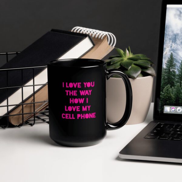 A black mug saying I love you the way how I love my cell phone