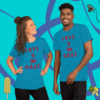 A man and woman posing for the camera wearing blue shirts.