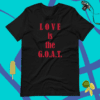 A black t-shirt with the words love is the g. O. A. T. On it
