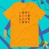 A yellow t-shirt that says love in different languages.