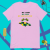 A pink t-shirt with some yellow and green shapes