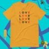 A yellow t-shirt that says love in different languages.