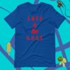 A blue shirt that says love is the g. O. A. T