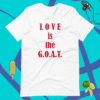A white t-shirt that says love is the g. O. A. T