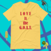 A yellow shirt that says love is the g. O. A. T