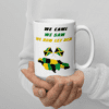 A person holding a coffee mug with jamaica on it.