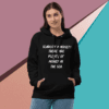 A woman wearing a black hoodie with the words " scarred by money ? there are plenty of money in the sea ".