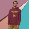 A man wearing a maroon hoodie with the words " scarcity of prosperity."