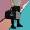 A man holding onto a duffel bag