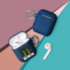A blue case next to an apple airpod.