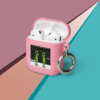 A pink case with a keychain attached to it.