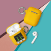 A yellow case next to an apple airpod.