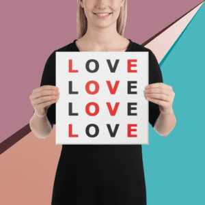 A woman wearing a black dress holding a square Love design