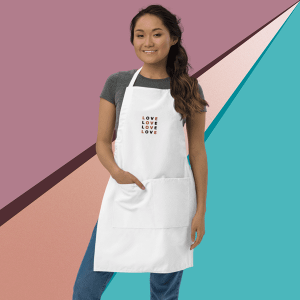 A small picture of a woman wearing a white apron over a gray shirt