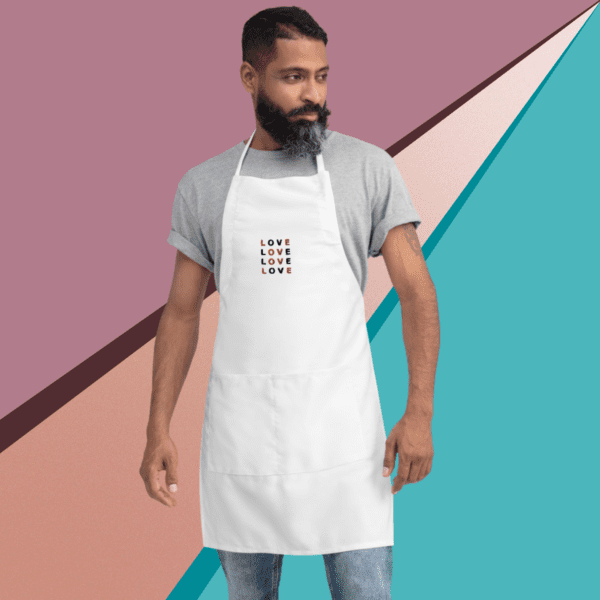 A small picture of a man wearing a gray shirt under a white apron