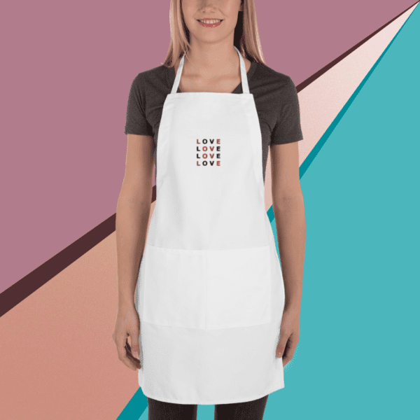 A small picture of a woman wearing a dark gray under a white apron