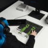 A small picture of a blue-haired person using a mouse pad
