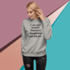 A woman wearing a gray sweatshirt with the words " i am not always sarcastic sometimes."