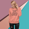 A woman wearing an orange sweatshirt with the words " i am not always sarcastic sometimes."